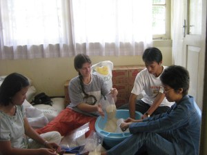 Aid workers from Indonesia, Australia and The Phillipines work together to package food for refugees Helping package food for refugees after an earthquake